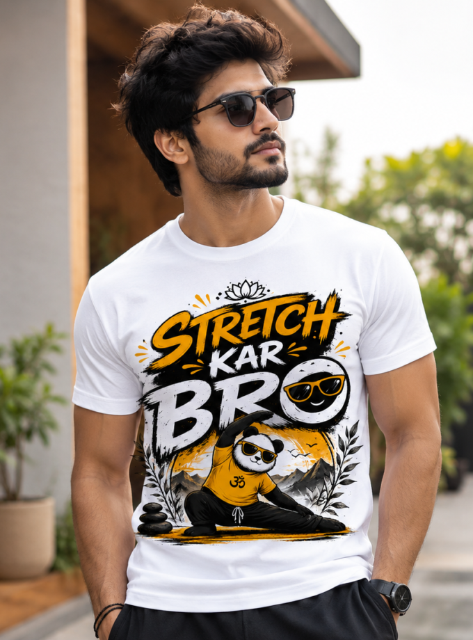 Man wearing a white graphic t-shirt with bold orange and black letters, sunglasses, standing outdoors.