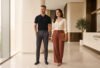 Smart office outfit ideas for Indian professionals - man in polo tee and woman in structured top at a modern workplace